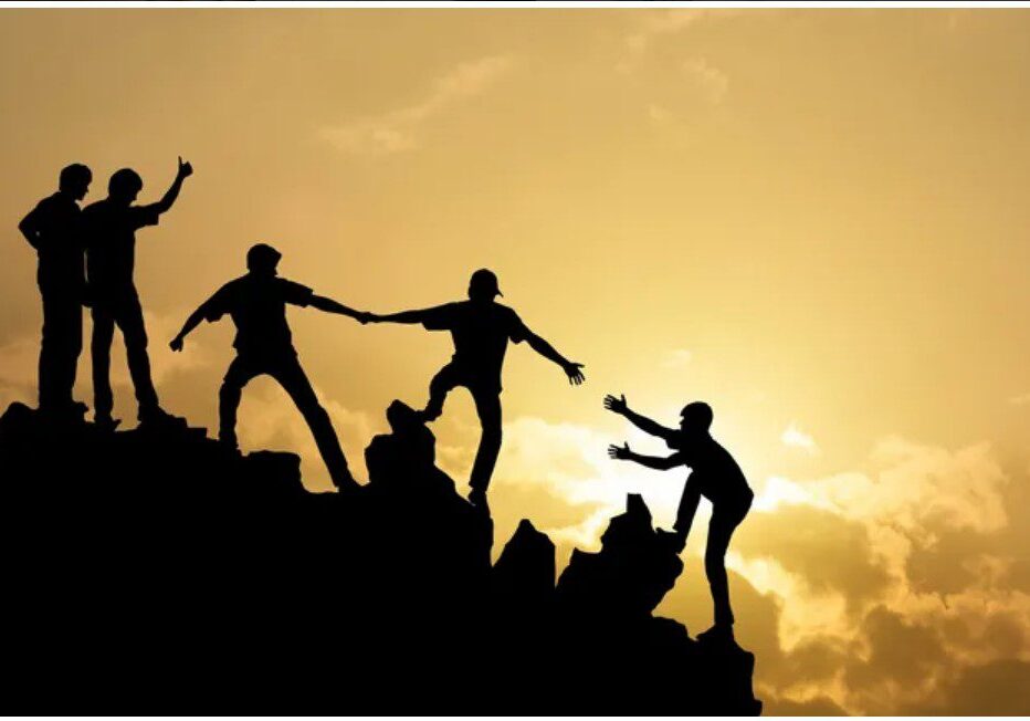 A group of people climbing up the side of a mountain.